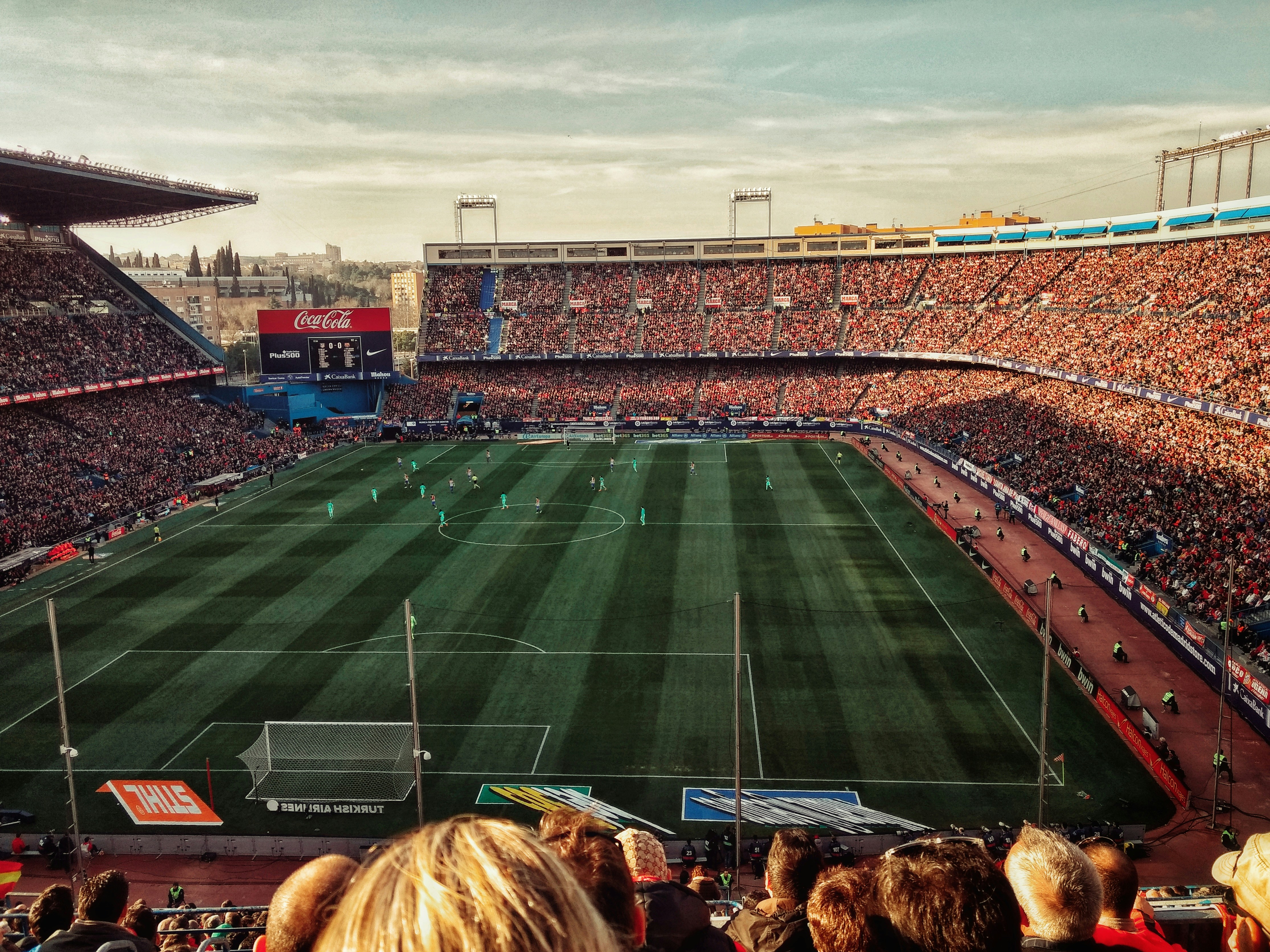 A soccer stadium full of people is pictured during the day.